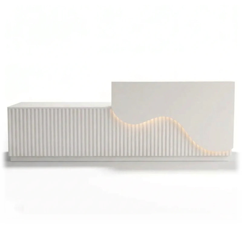 Faye reception desk with fluted front and lit wave curve, studio view