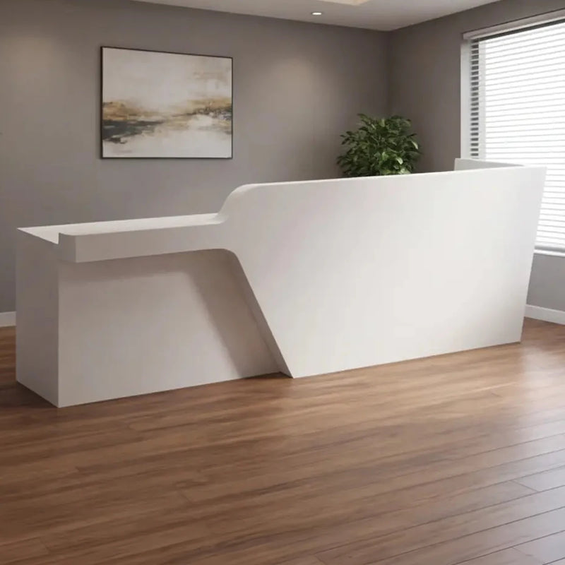 Cyrene desk angled by a bright window in a salon reception