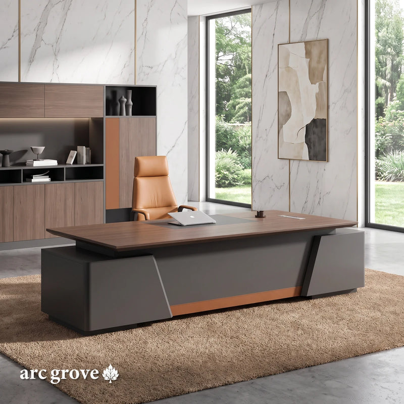 Alford · Modern L-Shaped Executive Desk, three-quarter view from the visitors' side, in an office with white marble walls with fine gray veins and brass trim