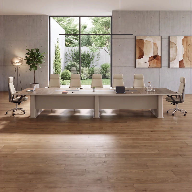 Alwyn large conference room table in walnut with ten white chairs in a gray room with a stone floor
