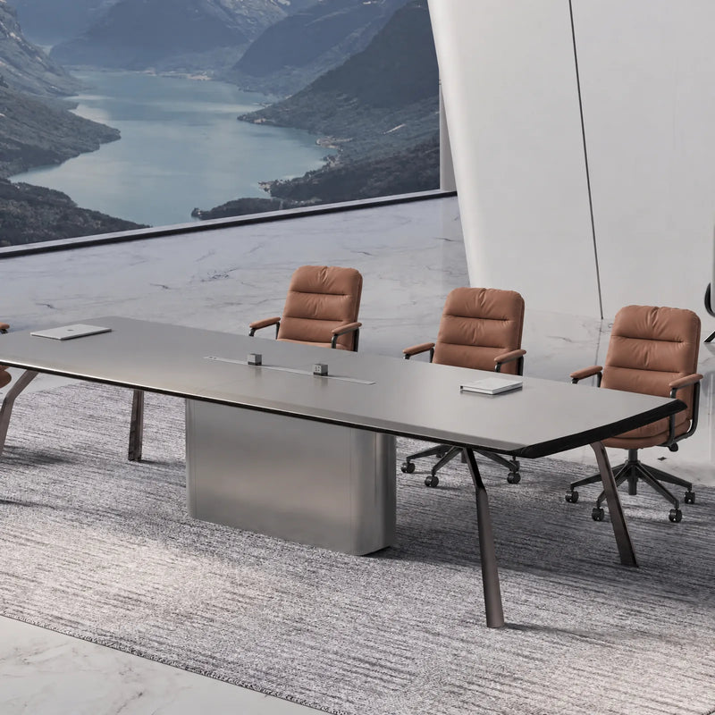 Amalga coworking meeting table for 12 with cognac leather chairs beside a floor-to-ceiling lake view