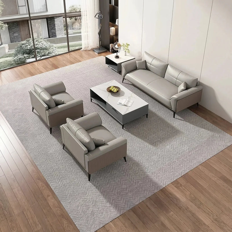 Boren gray leather conversation set on a herringbone rug in a bright lounge, overhead view