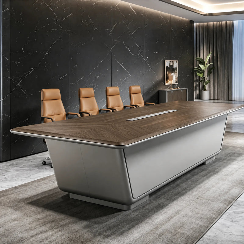 Amiens executive meeting table in gray with a wood-tone top, four chairs, near a plant and credenza