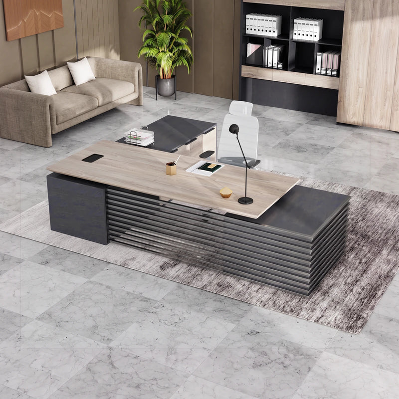 Anderson executive standing desk at sitting height in a warm modern office with lounge seating
