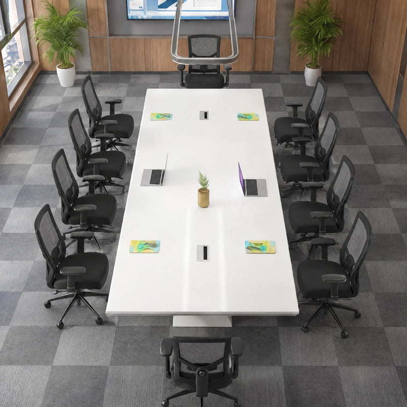 Angled overhead view of the Ardyn white conference table seating 12 in black mesh chairs on checkered carpet