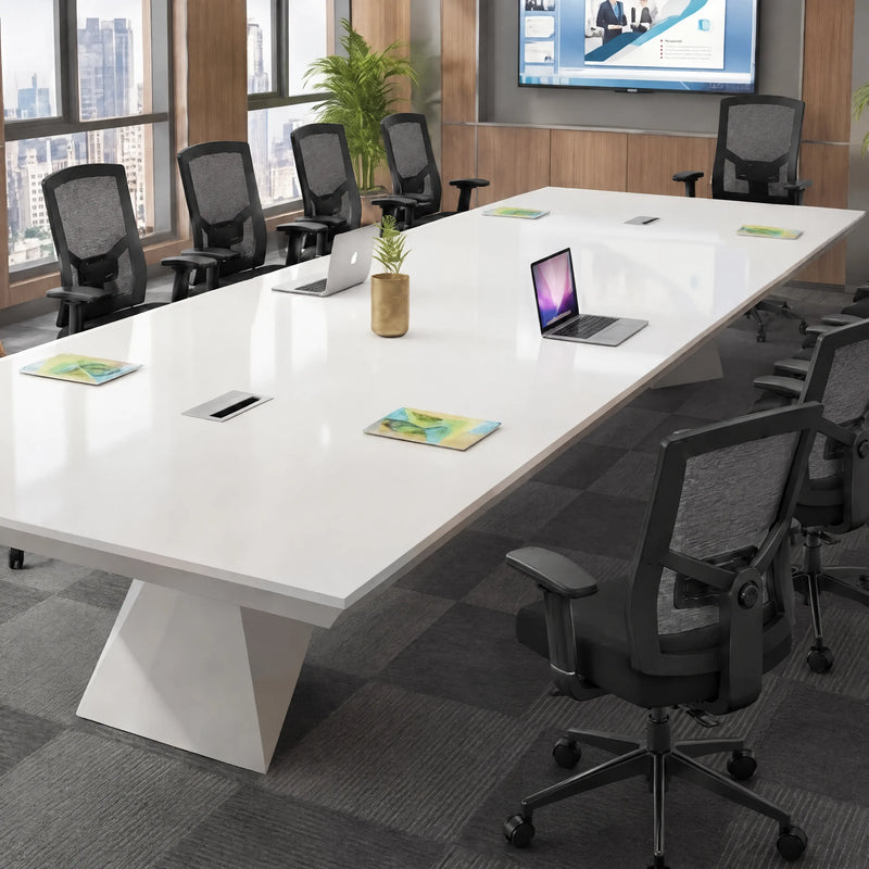 Ardyn white tabletop close up with a laptop, notepads and a flip-up cable management grommet