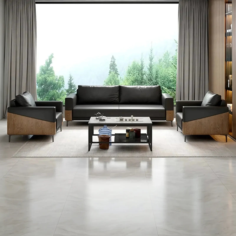 Koster black lounge set with walnut panels around a coffee table by a window overlooking pine forest
