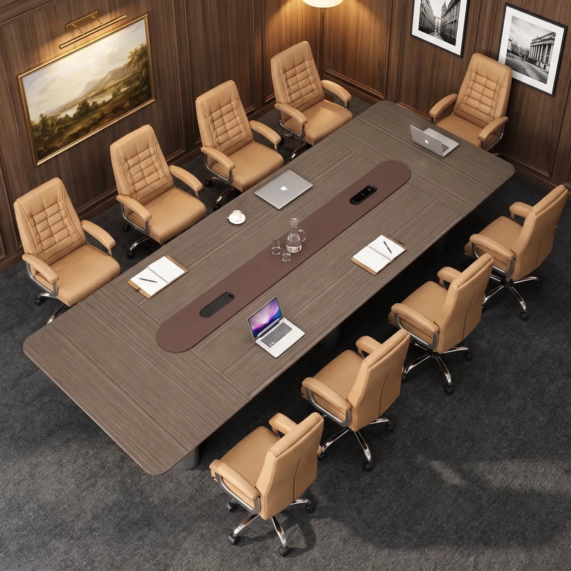 Overhead view of the Callum conference table with laptops and phones plugged into the powered center rail