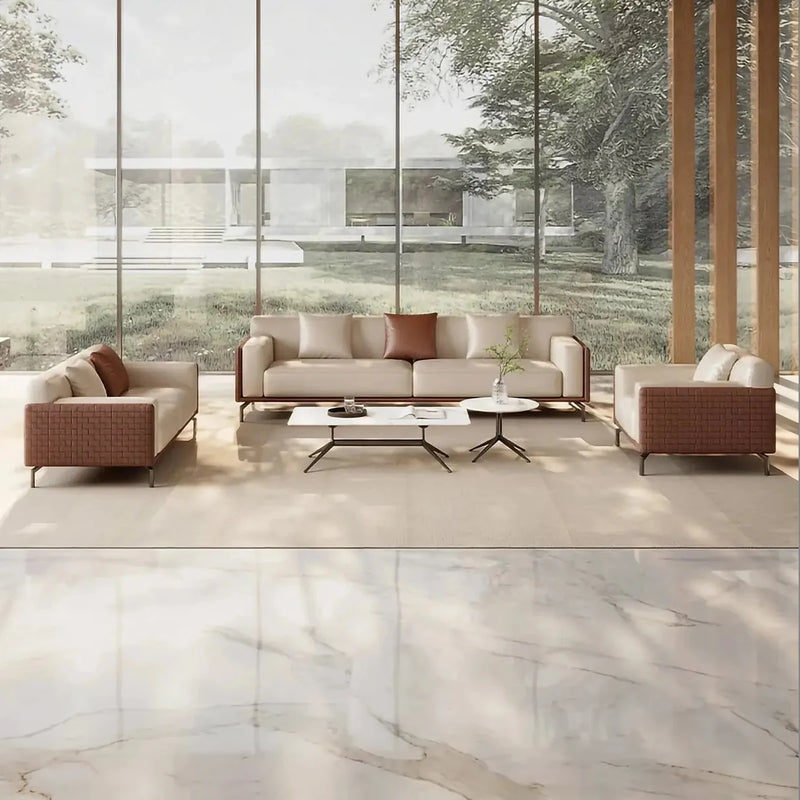 Utö beige and brown leather lounge set in a glass-walled pavilion overlooking a lawn