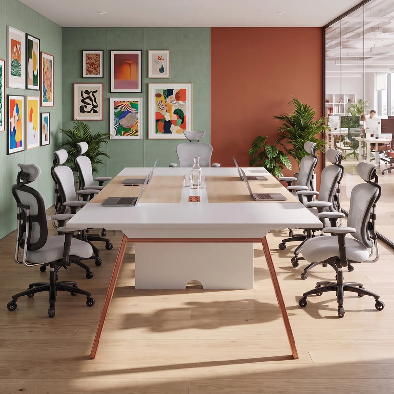 Comity collaborative meeting table seating 8 facing a wall display in a bright conference room