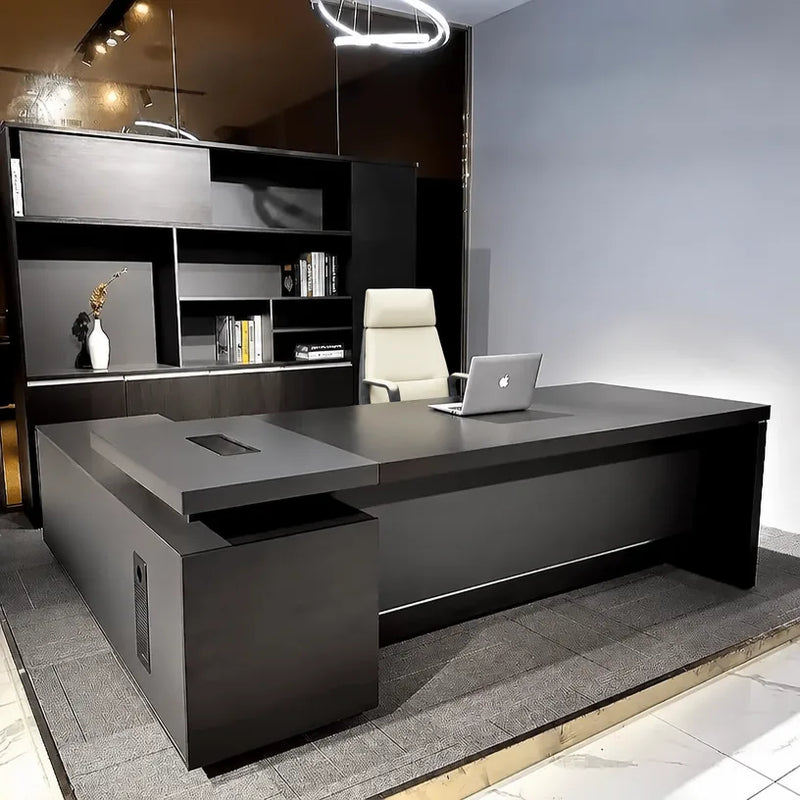 Photo of the Danton desk, right return, backed by dark shelving