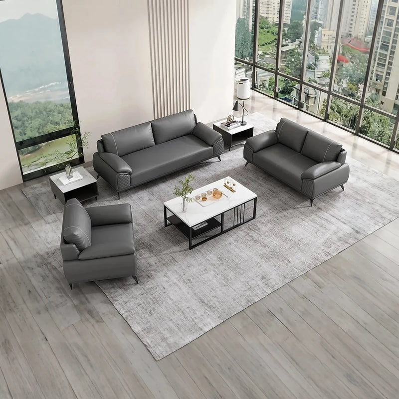 Bolmen gray leather conversation set on a pale rug beside floor-to-ceiling windows, overhead view