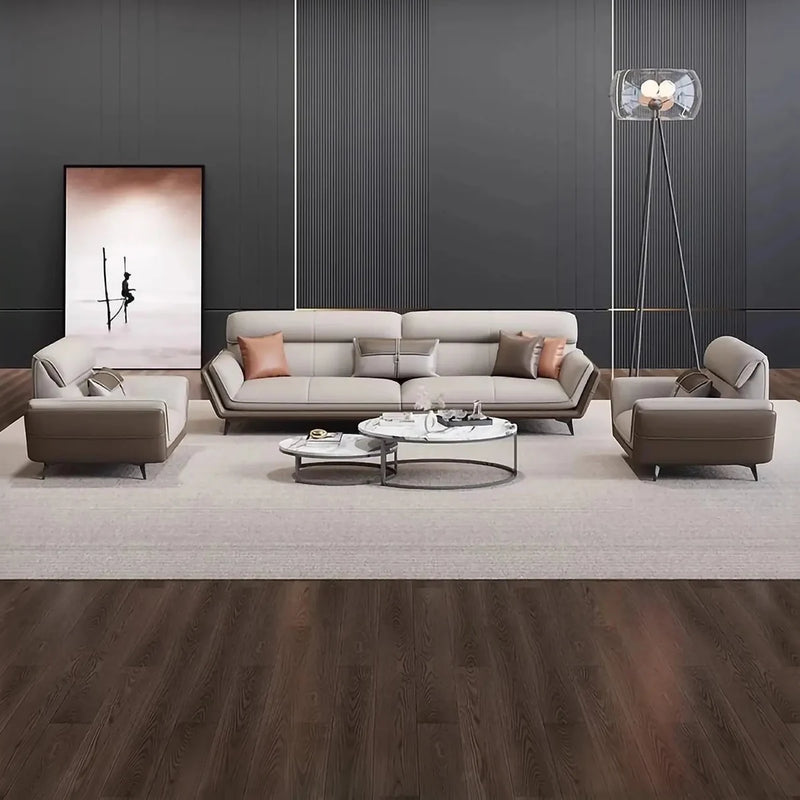 Skövde beige leather lounge set on a rug in a dark-paneled lounge with a tripod floor lamp