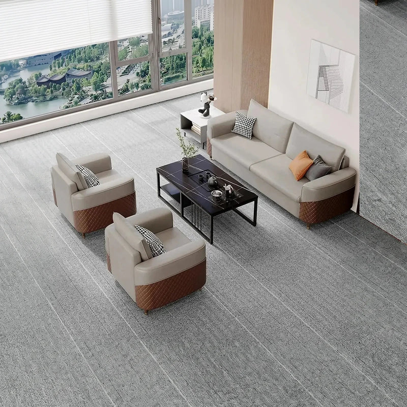 Fryken beige leather conversation set with orange cushions around a black coffee table beside tall windows