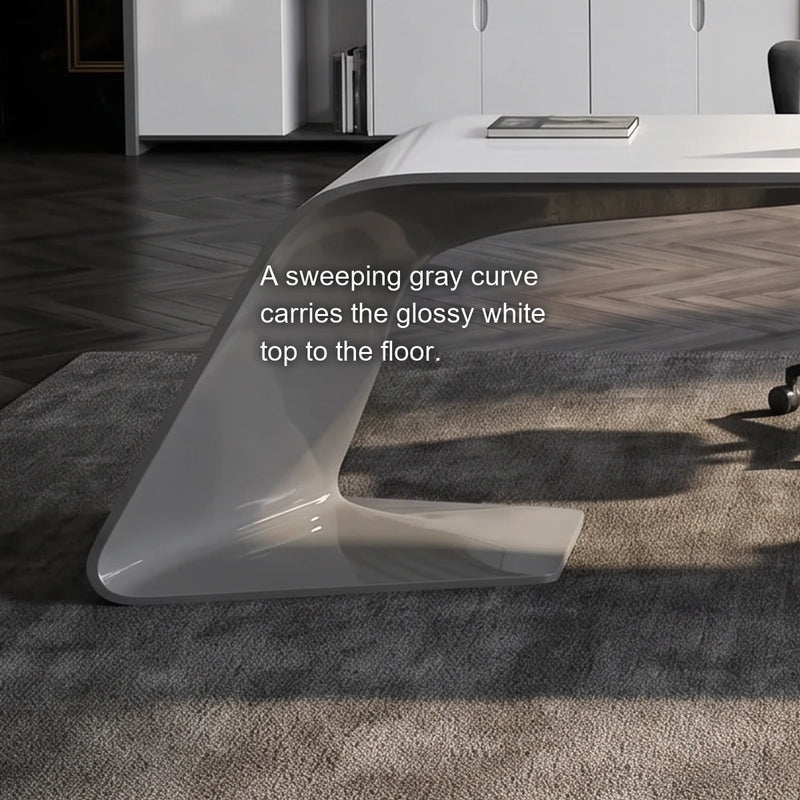 Close-up of the Godel desk's sweeping gray curved leg under the glossy white top