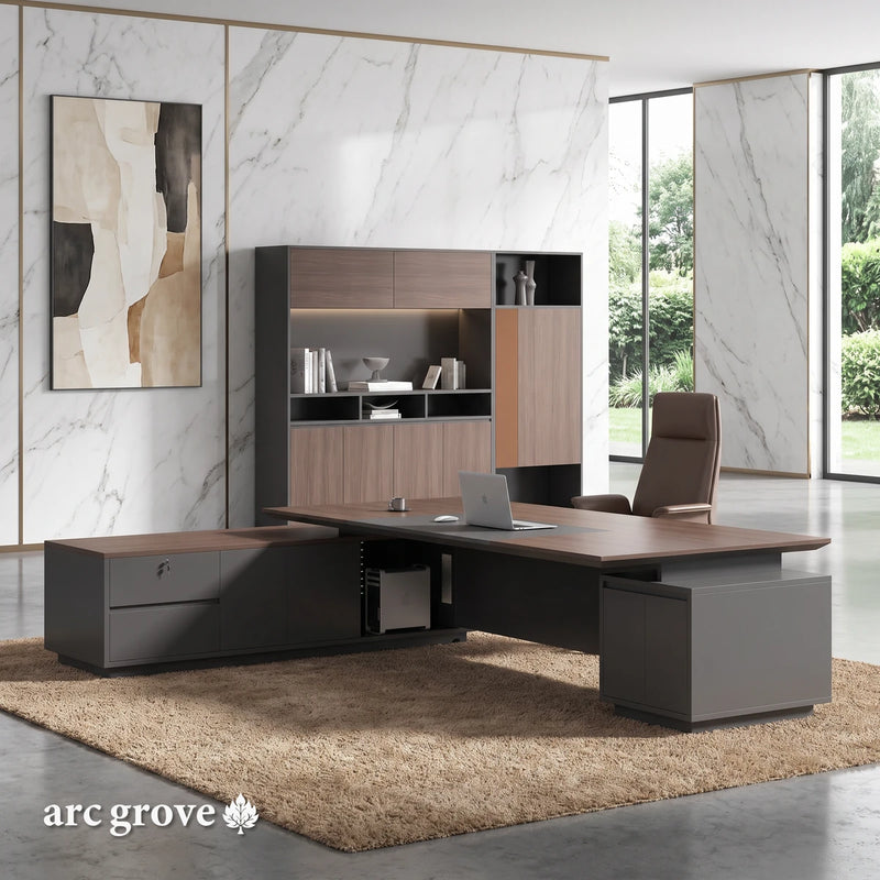 Alford · Modern L-Shaped Executive Desk, three-quarter view from the user's side, in an office with white marble walls with fine gray veins and brass trim