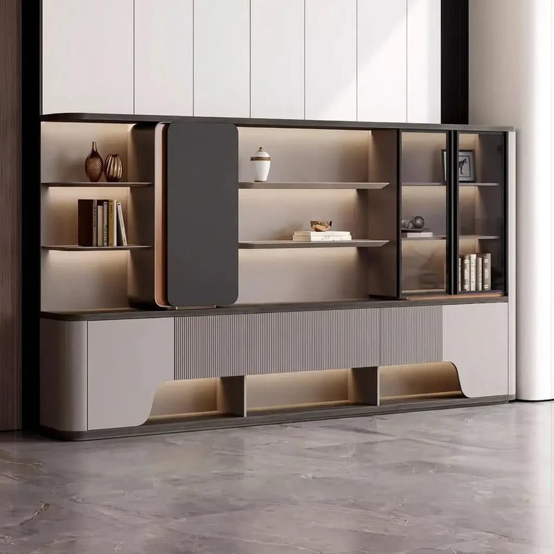 Merit office shelves front view in a bright room, integrated lighting, floating dark door and glass-door cabinet