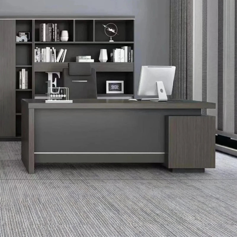 Hadley desk with monitor in a gray executive office with shelf wall