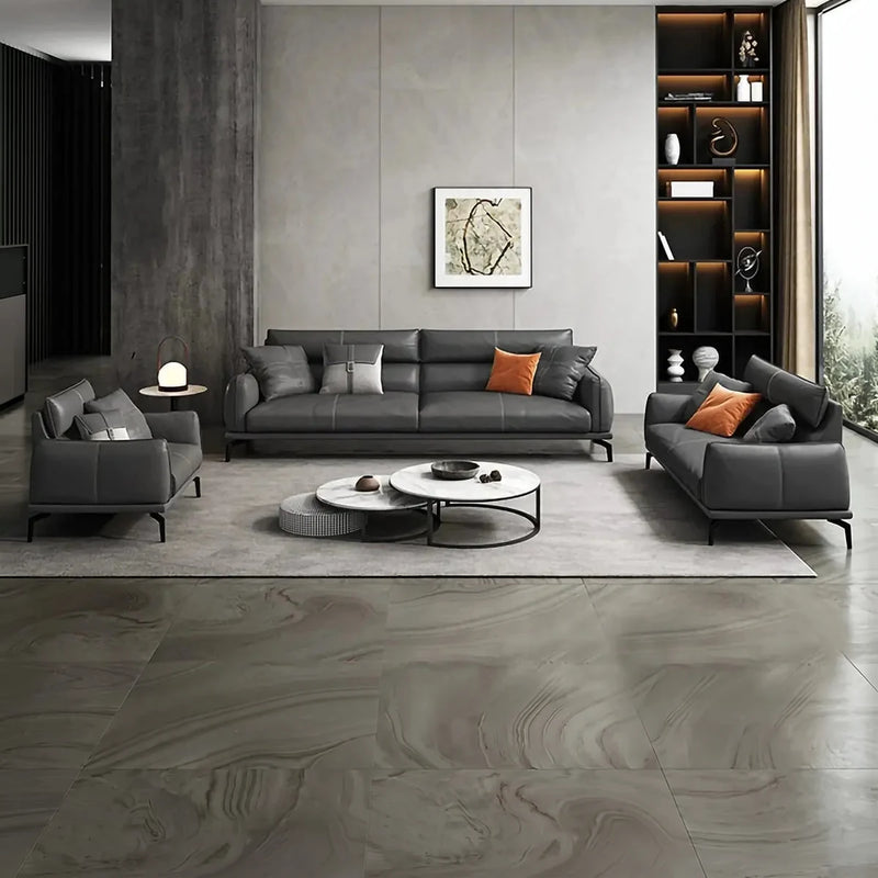 Vindö black leather conversation set in a gray lounge with a lit display shelf and framed art