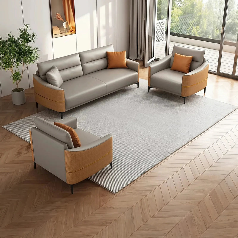 Fårö beige and fawn leather conversation set with orange cushions on a rug beside a balcony door