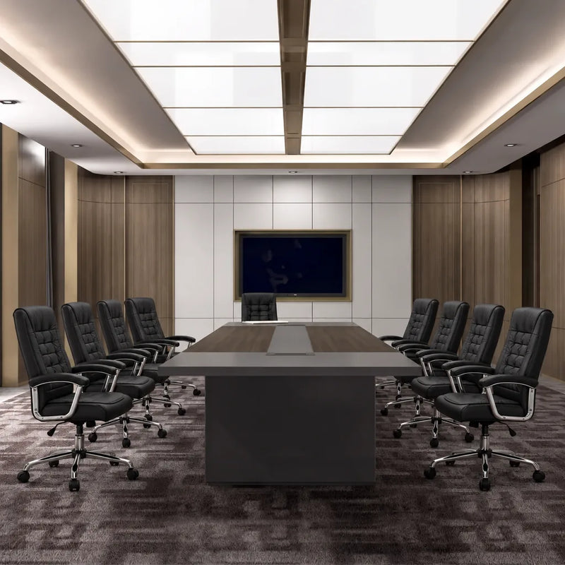 Maxum contemporary conference table with eight black leather chairs facing a wall-mounted screen