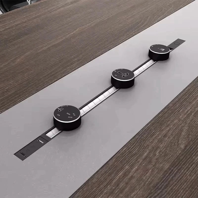 Close-up of three round pop-up charging modules on the Medley gray oak center runner