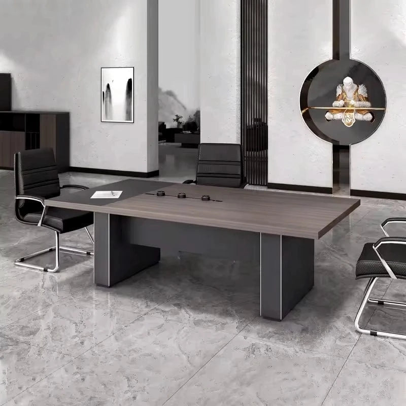 Medley meeting table on slab legs with a black chair, angled view in a stone-floored room
