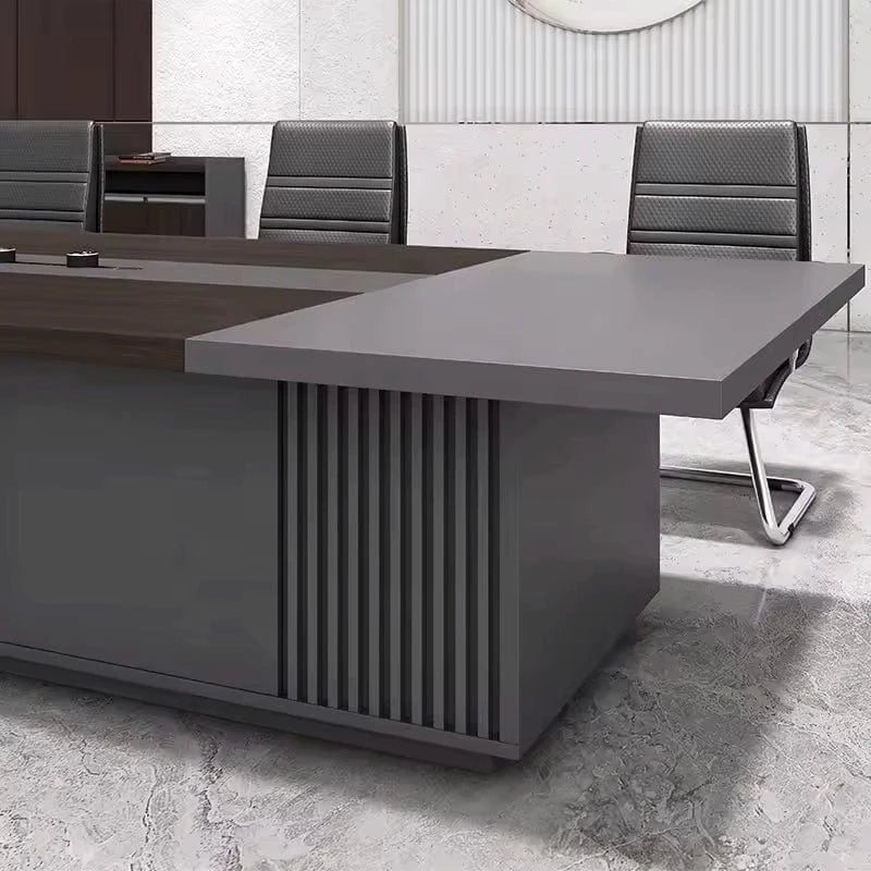 Close-up of the Medley slatted pedestal end and gray tabletop with a black chair