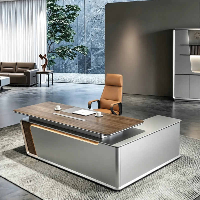 Modena desk at sitting height in a blue-stone executive suite