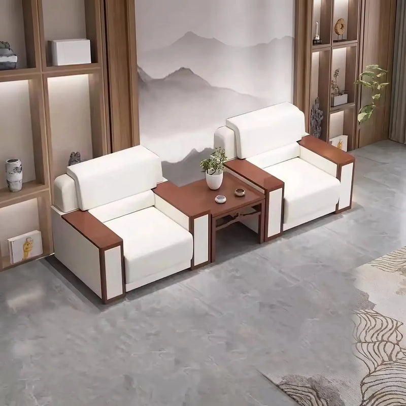Two Boden white arm chairs flanking a wooden side table in a lounge with an ink-wash mural