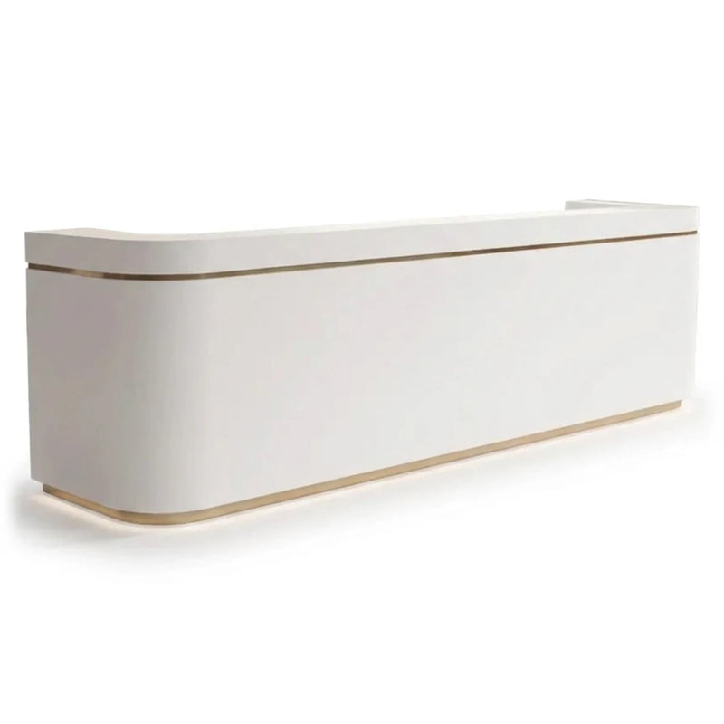 Iselle reception desk in white with brass trim line and lit base, studio view
