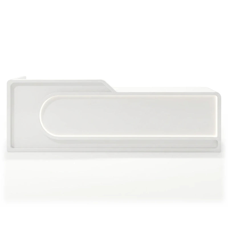 Nyssa reception desk with lit capsule outline, angled studio view