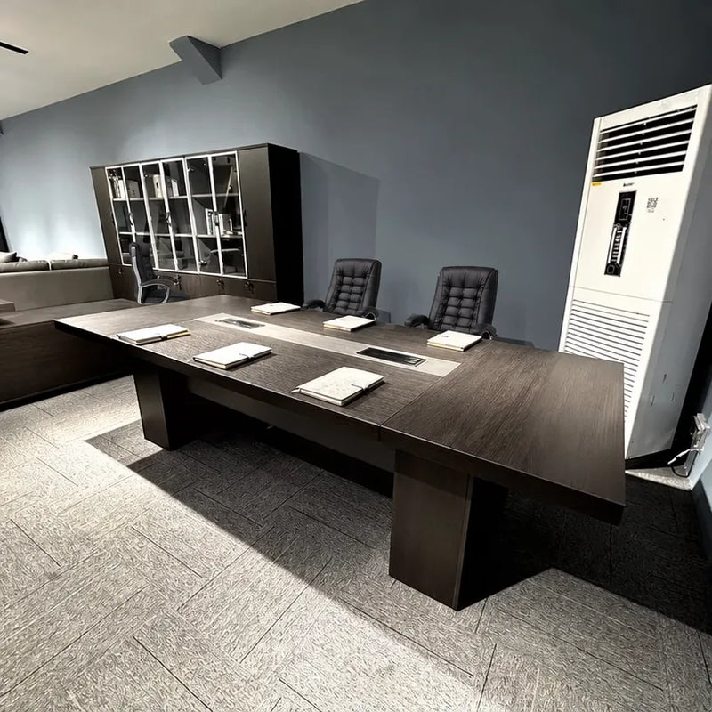 Prime conference table photographed from the side in an office with a bookcase and floor AC unit