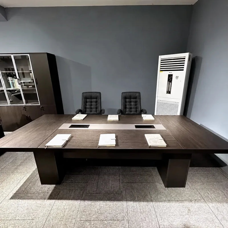 Prime brown conference table viewed straight on with notepads at each seat, client office photo