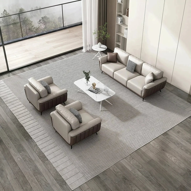 Resarö beige leather conversation set on a striped rug in a lounge with a balcony view, overhead view