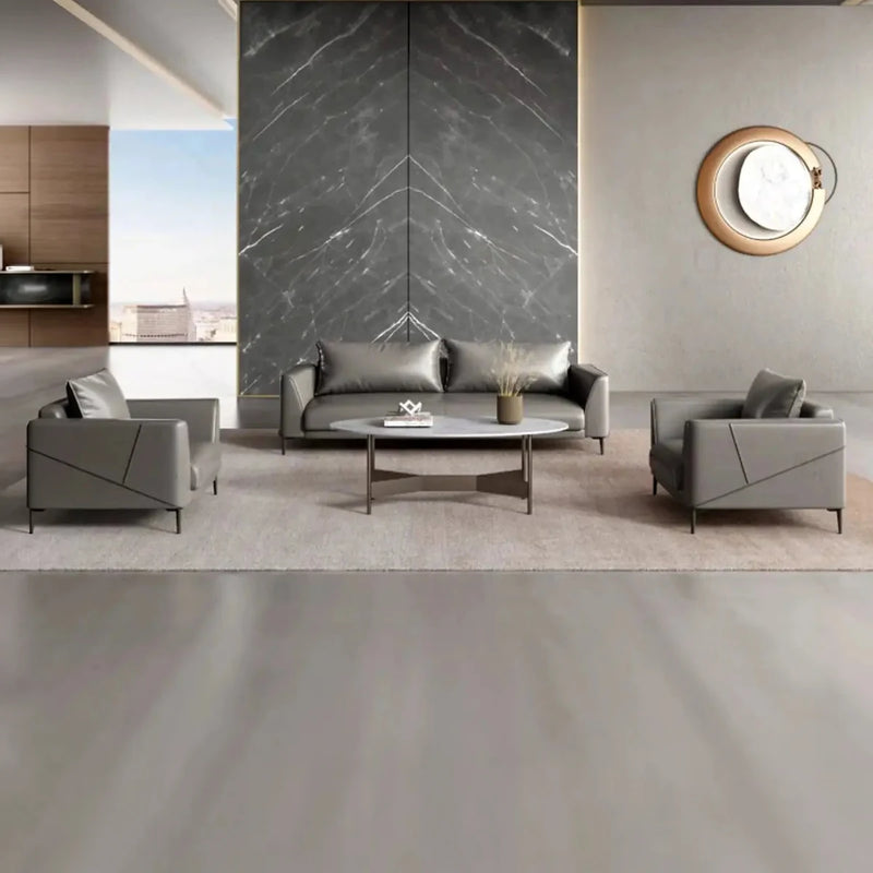 Lerum gray lounge set with a round coffee table in a lobby with a dark stone feature wall