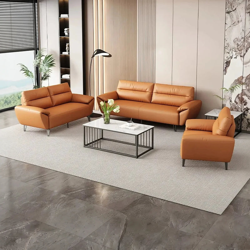 Ystad orange leather lounge set around a white coffee table in a bright lounge with a pagoda-print wall