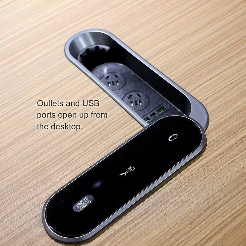 Close-up of the pop-up power module with outlets and USB ports in the Halsey desk