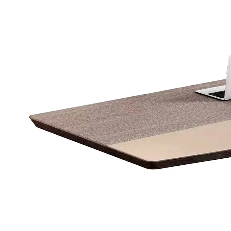 Corner detail of the Lyric gray oak top with beige center panel and a laptop