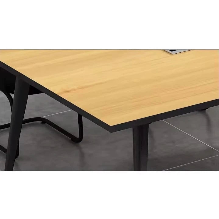Close-up of the Harvard elm tabletop corner and tapered black steel leg