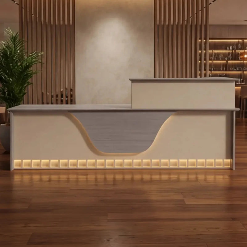 Ada front desk with integrated LED lighting in a hotel lobby with wood slat walls