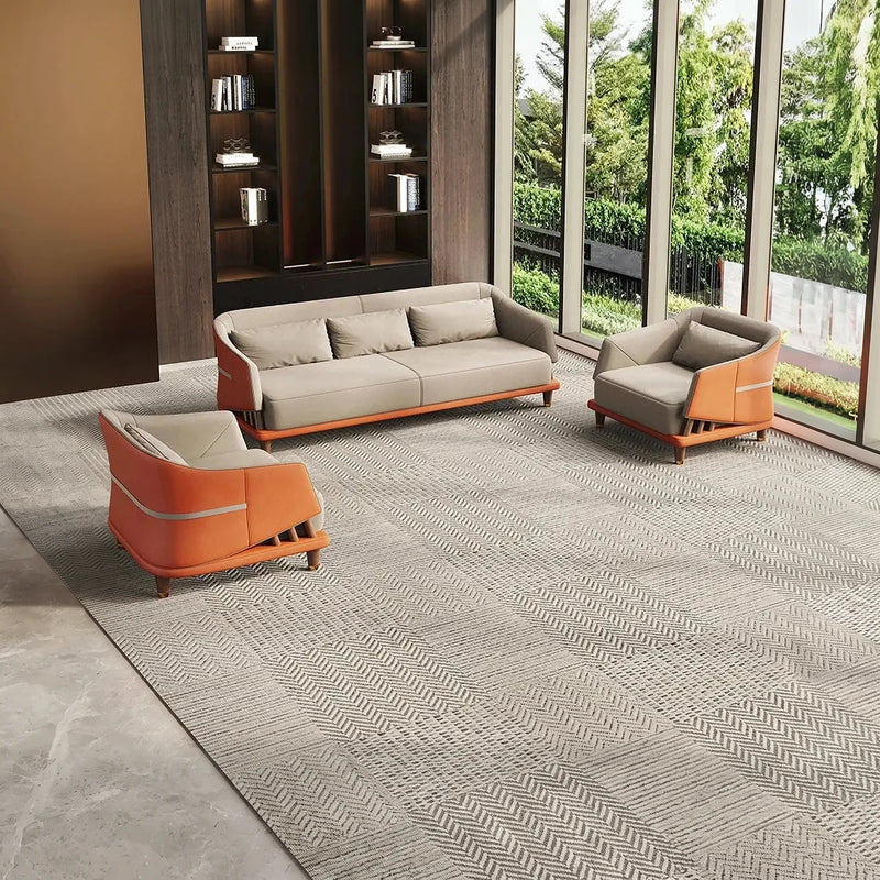 Sommen off-white and orange lounge set on a patterned carpet beside a garden window and bookcase