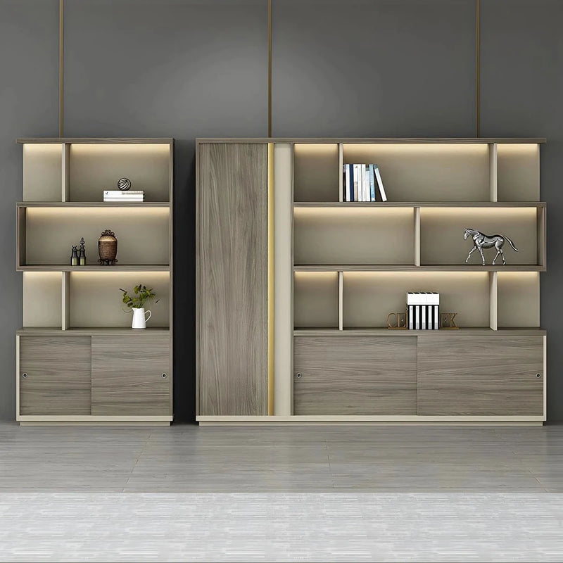 Ashwyn office shelves with integrated lighting in a gray room, walnut wardrobe door between lit display shelves