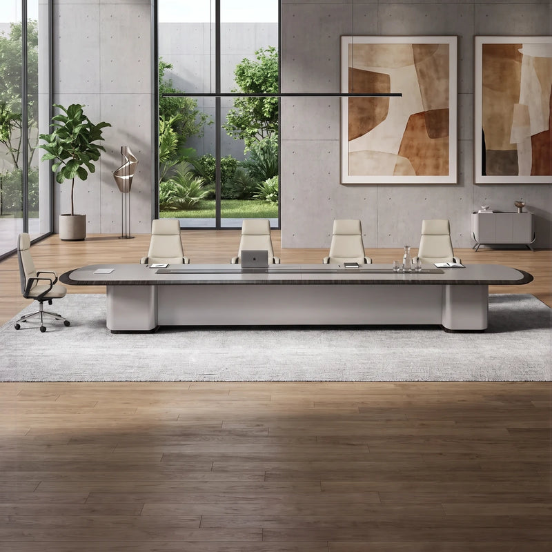 Zenith grand conference table with cream leather chairs in a stone-floored room overlooking snowy mountains