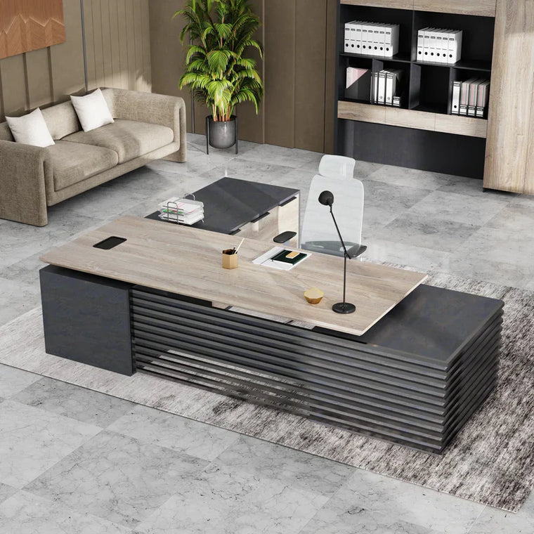 Height-adjustable L-shaped executive standing desk in an office