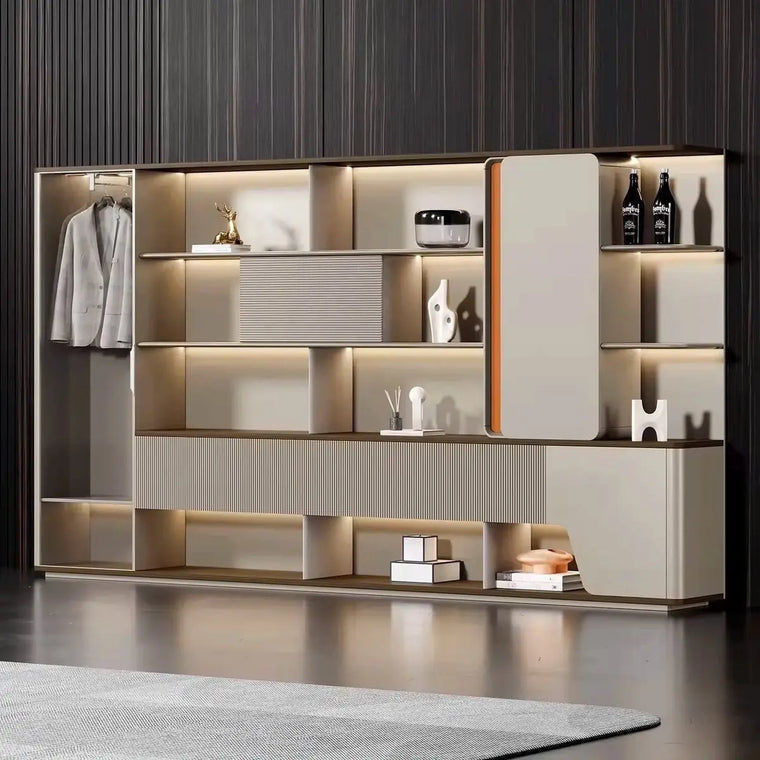 Full-height backlit shelving wall styled with books and objects against a dark paneled wall