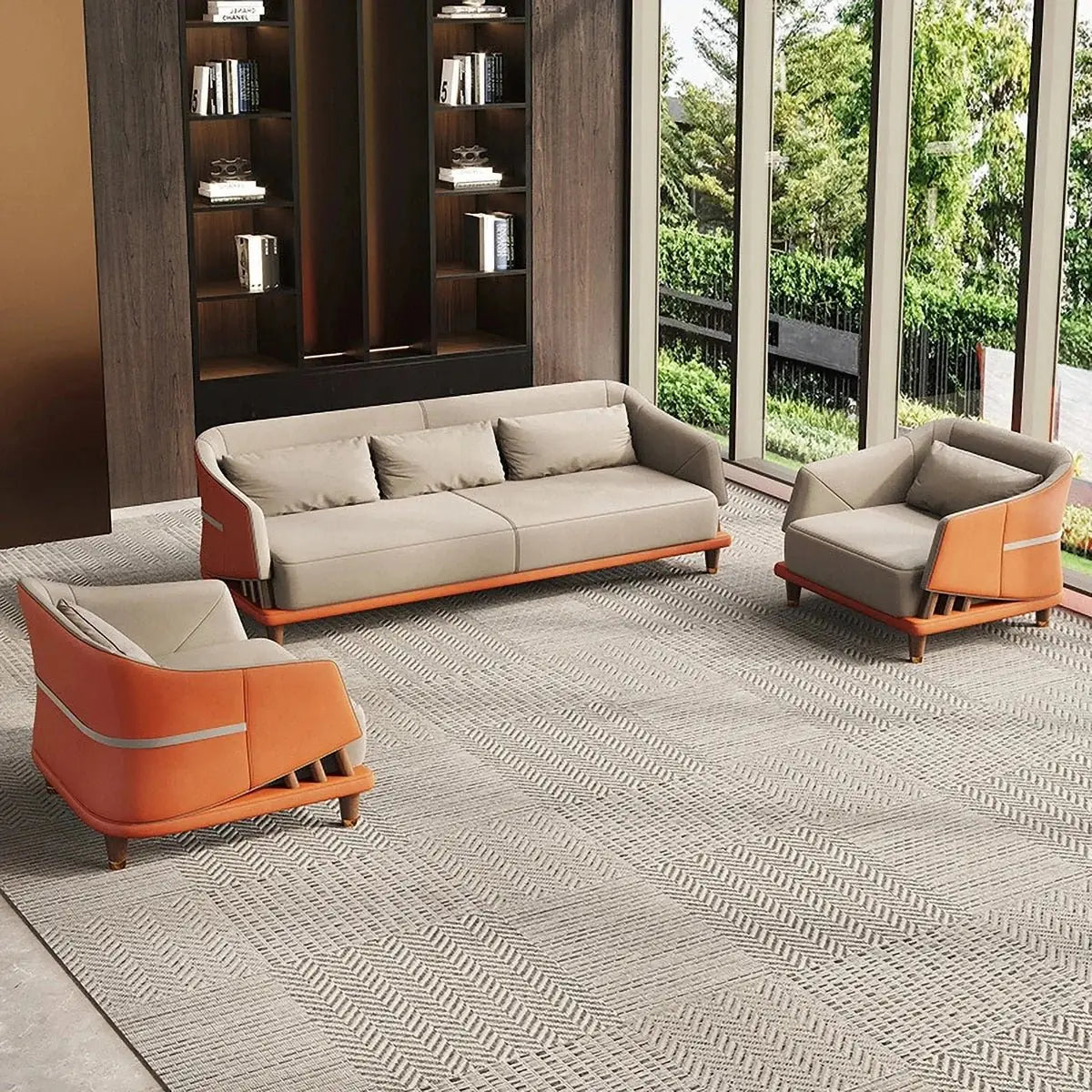 Executive office lounge seating area with a sofa and armchairs on a rug beside a greenery-filled window