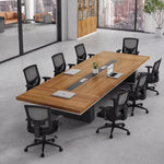 Accord walnut meeting room table with eight black mesh chairs in a glass-walled office