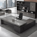 Acumen executive desk in gray oak, left return configuration, in a downtown corner office
