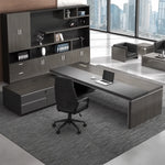 Acumen desk in gray oak paired with a matching executive storage wall in a city office
